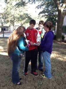 A student study group uses QR codes to complete performance tasks during a field trip.